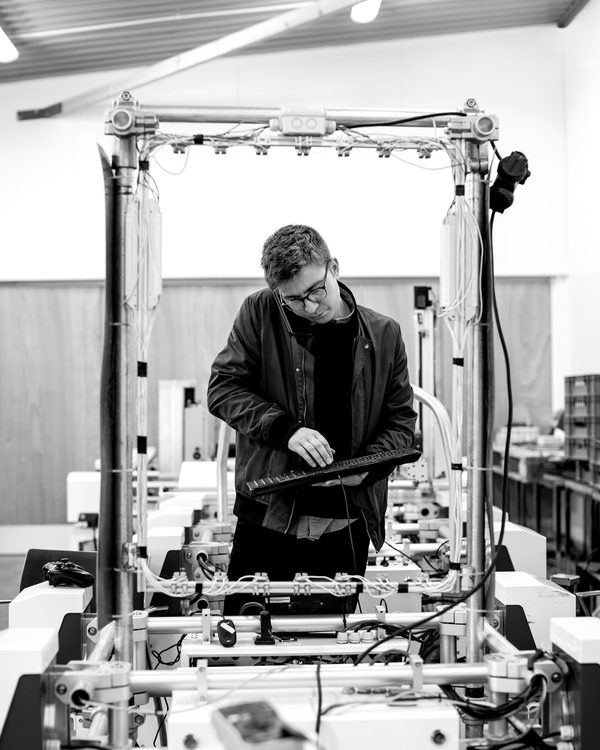 An engineer working at a gantry rig on a shop floor