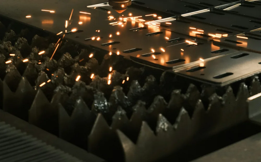 A laser cutting steel plate, with sparks