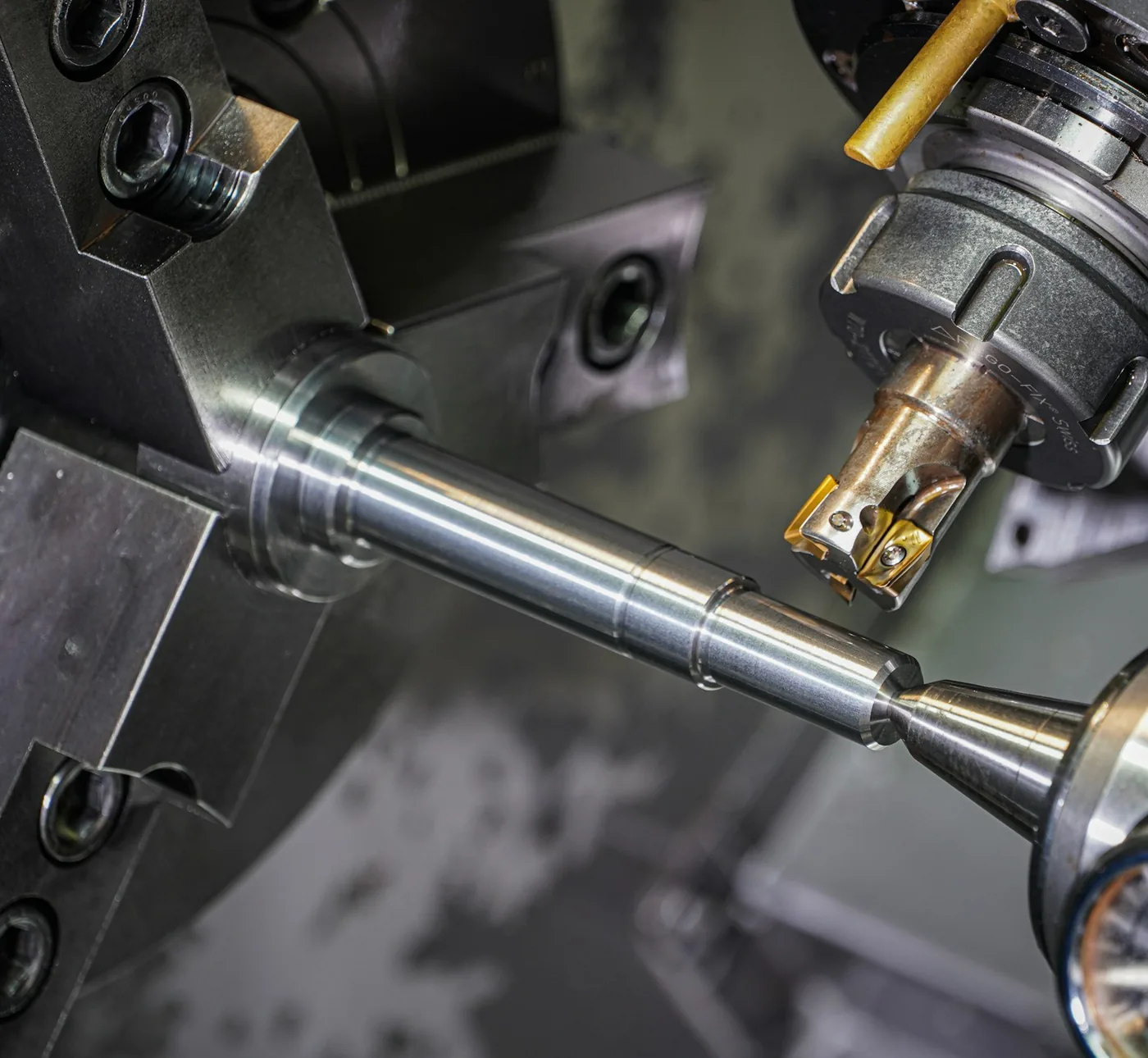 A steel shaft being turned in a lathe