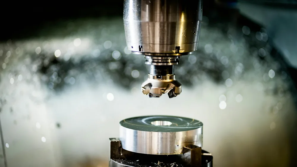 A face mill above a turned aluminium part
